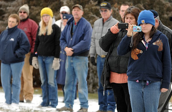 <p>Sarah Peterson and her mother, Mary Peterson, both of Columbia
Falls, record the posting of the colors by the Civil Air Patrol
Honor Guard on Friday morning at Glacier Memorial Gardens cemetery
north of Kalispell. This is the second laying of wreaths on the
graves of veterans. In mid-December 175 wreaths placed as part of
the Wreaths Across America were stolen from the gravesites.</p>