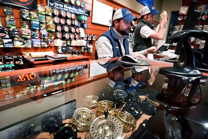 &lt;p&gt;Mike Beard, left, inputs bookkeeping records as Pat Way prepares a customer's Christmas order Monday at Orvis Northwest Outfitters.&lt;/p&gt;