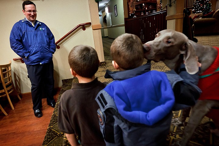 &lt;p&gt;Mike O'Brien, general manager of the Holiday Inn Express &amp; Suites, talks with Adam Achziger's sons as they visit with the hotel dog Thursday.&lt;/p&gt;