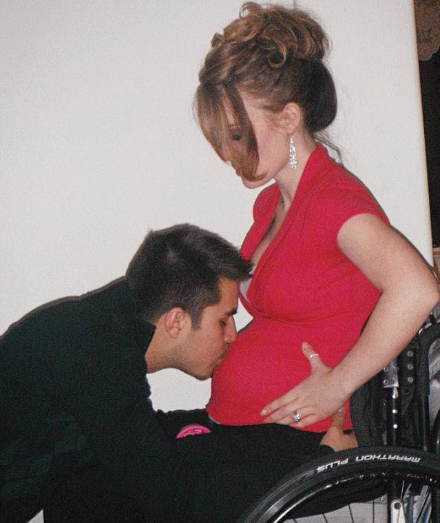 <p>Shannon Barnes kisses his wife during her wheelchair-bound pregnancy. Being paralyzed and pregnant was a challenge because  the spasms she experienced caused her to fall out of her wheelchair multiple times.</p>