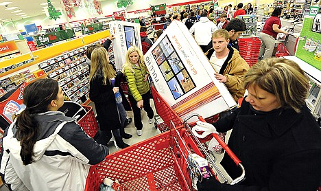 &lt;p&gt;Shoppers scramble for door buster deals at Target, in Bowling Green, Ky., on Nov. 25. U.S. consumers spent at a lackluster rate in November as their incomes barely grew, suggesting that U.S. households may struggle to sustain their spending into 2012.&lt;/p&gt;