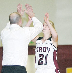 <p>Double high 5's for Sarah Pierce during the match-up with Stillwater Christian Thursday, Dec. 12. Coach Justin Young, left.</p>