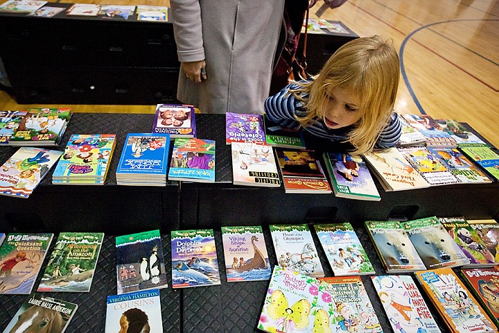 &lt;p&gt;SHAWN GUST/Press Piper Wasson, 6, browses the selection of books Thursday during the Santa and a Book event at Ponderosa Elementary in Post Falls. Hundreds of students had a chance to meet Santa, make Christmas decorations and write letters before receiving a book each. Spokane Teachers Credit Union sponsored a large portion of the event with a $1,000 donation.&lt;/p&gt;
