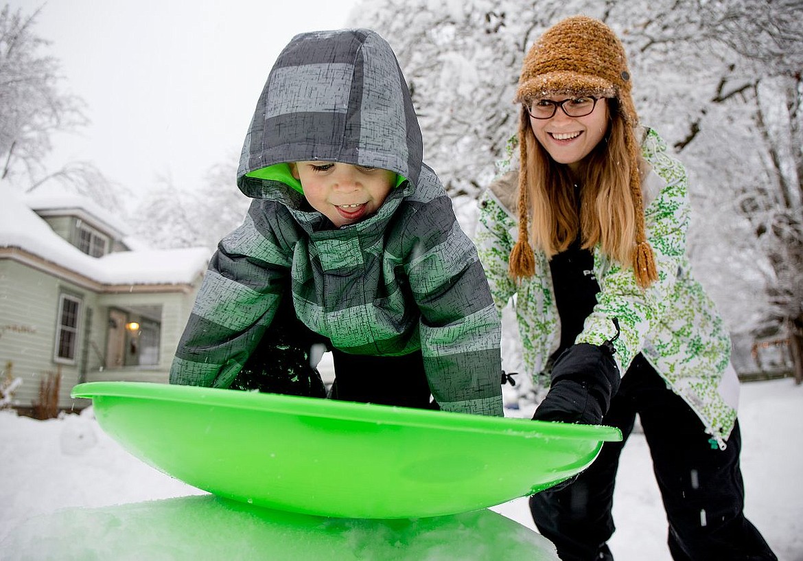 &lt;p&gt;Waylon Velin, 4, gets ready to conquer a hand-built sledding hill as Jaki Waldvogel helps him get situated on Wednesday in front of Jaki's home in Coeur d'Alene. Snow levels rose steadily throughout the day, making for perfect sledding conditions.&lt;/p&gt;