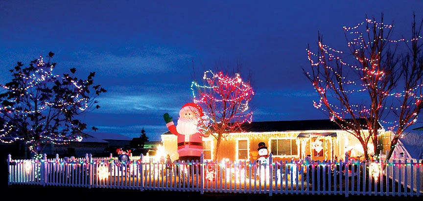 Santa waves to passerbys along Vince Lane in Moses Lake, one of many neighborhoods in town showing their Christmas spirit this season.