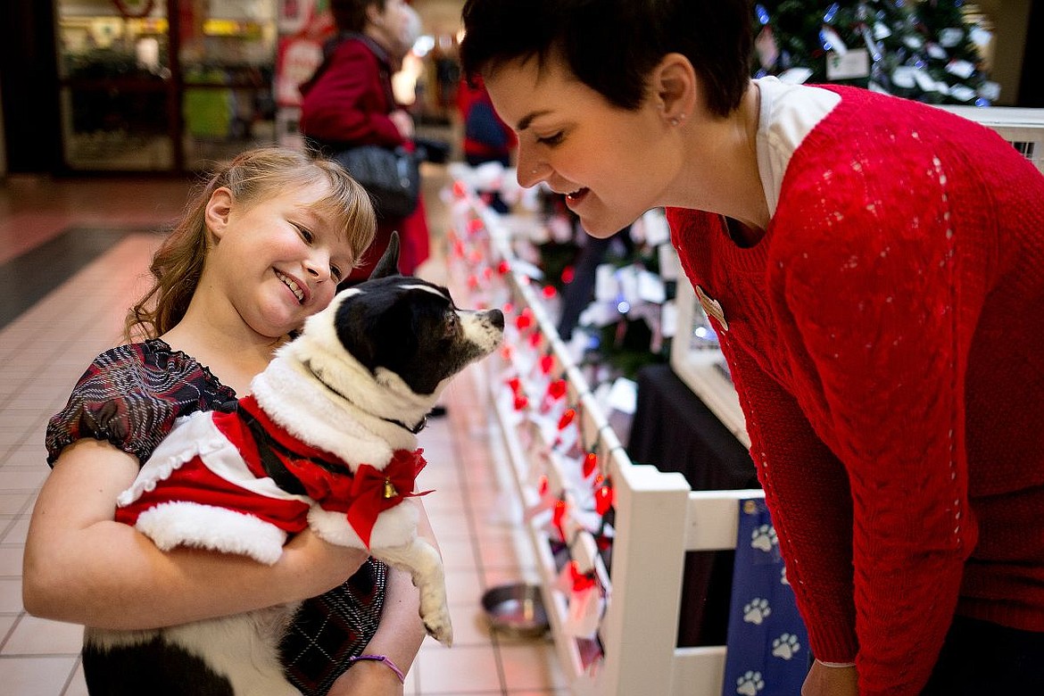 &lt;p&gt;Katherine Reiswig, left, holds 5-year-old Roxy the dog as Kootenai Humane Society Volunteer Coordinator Devin Laundrie watches on Wednesday at &quot;Holiday with the Humane Society&quot; pet adoption and fundraising event at the Silver Lake Mall in Coeur d'Alene. Reiswig, 9, came up with the idea for the event.&lt;/p&gt;