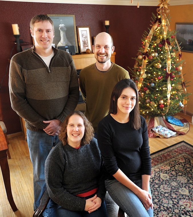 Cousins Travis Steindorf of Kalispell, back left, and Ryan Reichman of Tacoma, Wash., pose with their spouses, Erin Reichman, left, and Rachel Steindorf last week in Kalispell. Rachel Steindorf acted as the surrogate mother for the Reichmans&#146; twin babies.