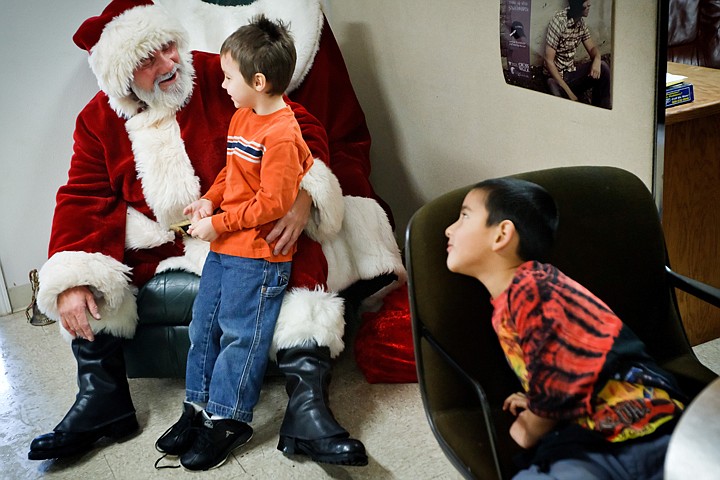 &lt;p&gt;JEROME A. POLLOS/Press Amynn LaFountain visits with Santa Claus as his brother Oscar Martinez waits his turn Tuesday during a Christmas party at Fresh Start in Coeur d'Alene.&lt;/p&gt;