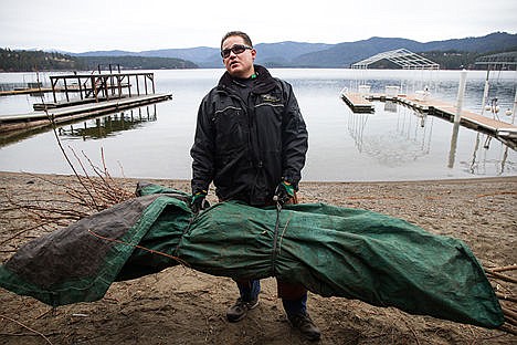 &lt;p&gt;Scott Cisneros, owner of Treepro Landscaping Company, picks up a load of Black Locust trees to haul away while working at a client&#146;s house on Tuesday afternoon. Cisneros was in a snowboarding accident on January 2nd, 2000 where he broke both femurs and was in a coma for two months.&lt;/p&gt;