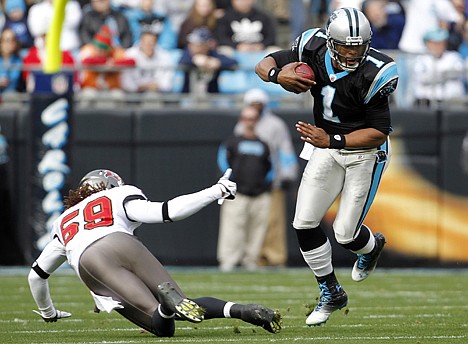 &lt;p&gt;Carolina quarterback Cam Newton (1) scrambles away from Tampa Bay's Mason Foster during the first quarter Saturday at Charlotte, N.C.&lt;/p&gt;