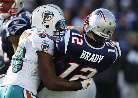 &lt;p&gt;New England Patriots quarterback Tom Brady (12) is sacked by Miami Dolphins linebacker Karlos Dansby (58) during the first quarter Saturday at Foxborough, Mass.&lt;/p&gt;