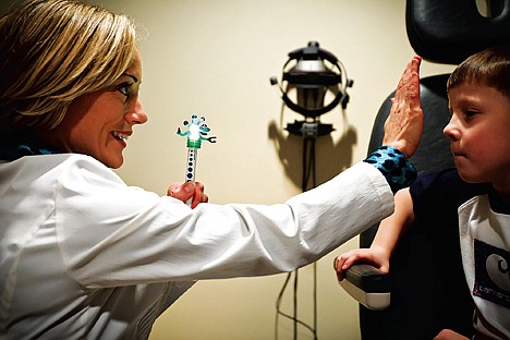 &lt;p&gt;Dr. Sarah Marossy performs an eye exam Tuesday on Kallen Higdon, 5, at her Post Falls practice.&lt;/p&gt;