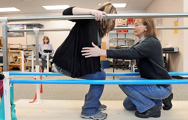 Kelsey Fey works with Kalispell Regional Medical Center Physical Therapist Kim Hawkins during their session on Friday, December 17, at The Summit.