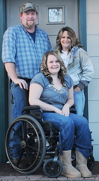 Kelsey Fey, 17, with her parents Brian and Michell outside their home on Wednesday, December 15, in Kalispell.