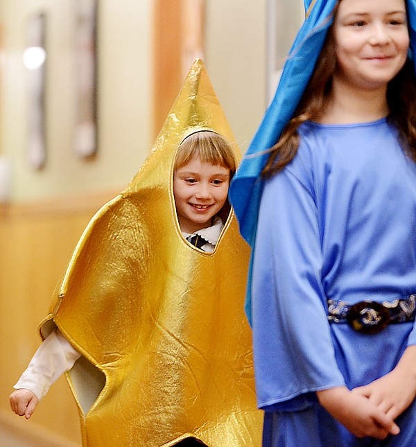 <p>First grader Hannah Danielson dressed as a star makes her way into the sanctuary of the Whitefish Church of the Nazarene for the Whitefish Christian Academy Christmas program on Friday, December 14.</p>