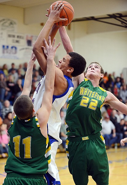 <p>Bigfork junior Christian Evans (33) shoots under pressure from Whitefish senior Jace Kalbfleisch during their game on Friday in Bigfork.</p>