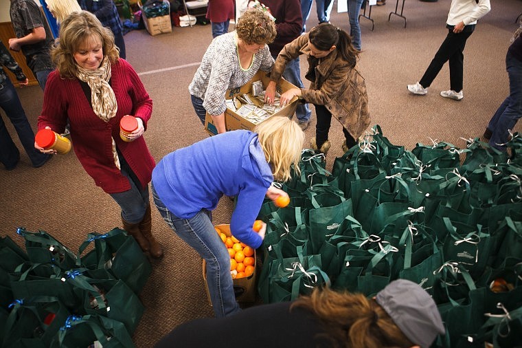 &lt;p&gt;Volunteers come together at Whitefish Presbyterian Church Wednesday morning in an assembly line to put together food bags. About 400 bags were delivered to local schools to hand out to students who are served by the reduced-price breakfast and lunch programs and need meal assistance over the Christmas break. The Whitefish Community Foundation and Whitefish PTA were involved in the project. Iron Horse Foundation contributed $6,000 to the project, and Buffalo Cafe owners Charlie and Linda Metzold coordinated the food for the bags. Students at Whitefish High School, Whitefish Middle School, Muldown Elementary, Whitefish Christian Academy and Olney-Bissell School will receive the bags.&lt;/p&gt;&lt;p&gt;&lt;/p&gt;