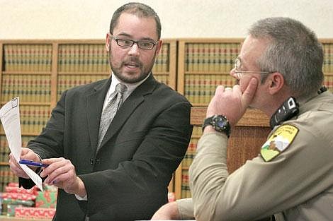 Photos by Sarah Leavenworth&lt;br&gt;Public defender Britt Cotter shows an e-mail admitted into evidence to Sgt. Jerry McKeen during an evidentiary hearing last Wednesday. McKeen was called as a witness for the prosecution and defense in the case Aleta Rogers, charged with 29 counts of animal cruelty.