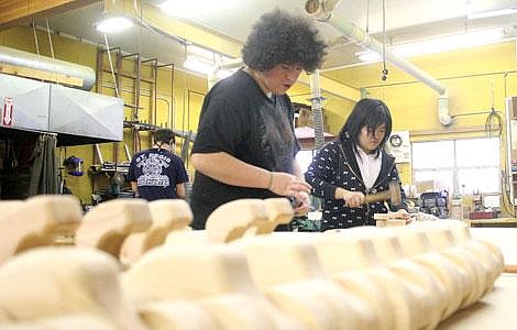 Photo by Aaric Bryan&lt;br&gt;St. Regis students Zach Lott and Palm Preechapun put the finishing touches on a toy car for the Women in Timber food baskets in the St. Regis wood shop Tuesday.