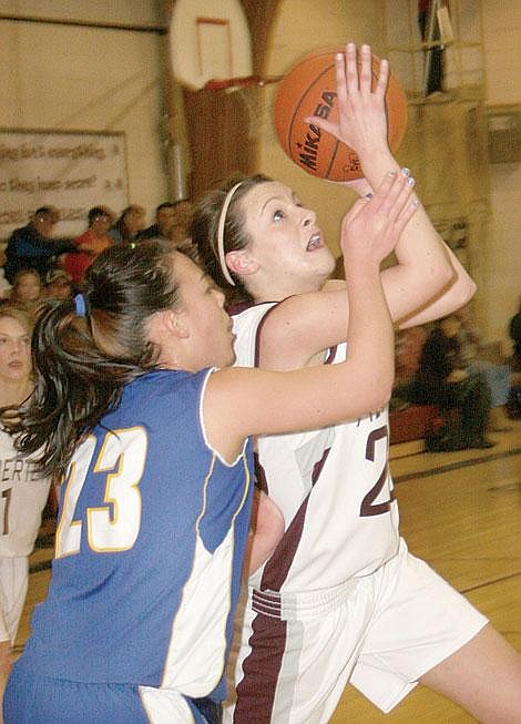 Photo by Aaric Bryan&lt;br&gt;Alberton's Nettie O'Rourke goes up for a shot over a Victor defender in Alberton Saturday.