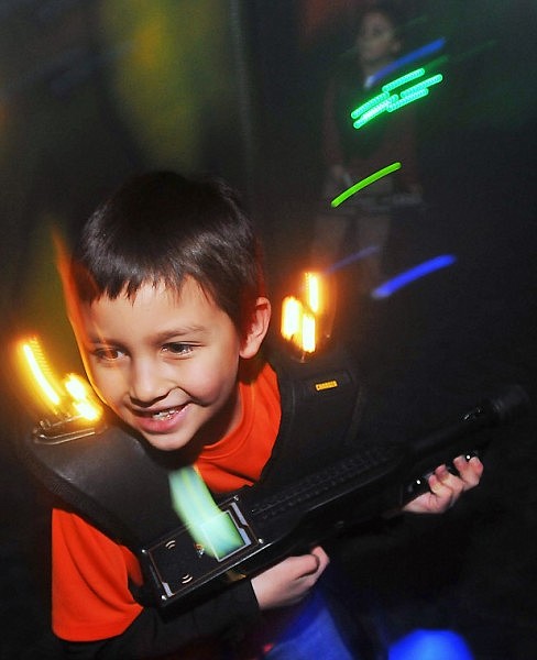 Alex Muzquiz, 7, runs away from the opposing team in a game of Laser Tag with friends.