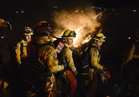 &lt;p&gt;Firefighters battle a wind-driven brush fire in Simi Valley, Calif. on Wednesday. Strong Santa Ana winds spread the fire quickly; however, firefighters gained the upper hand in several hours after an all out assault using water dropping helicopters, engines, and hand crews.&lt;/p&gt;