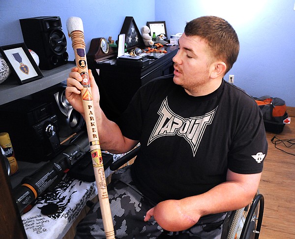 &lt;p&gt;Tomy Parker displays a hand-crafted cane made for him by a
fellow Marine he met in Maryland. The cane is decorated with images
Parker requested, including the American flag, the Purple Heart,
the Marine Corps seal, his unit seal and the soldier&#146;s
memorial.&lt;/p&gt;