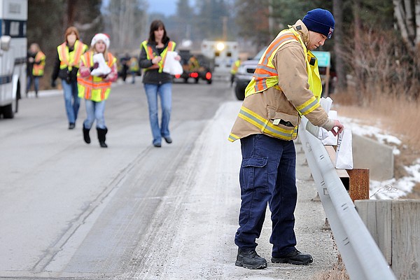 &lt;p&gt;Volunteer Firefighter Glen Hartman of the Evergreen Fire
Department and a group of volunteers from the fire department and
the community place luminarias at the bridge at Rose Crossing Road
on Saturday evening. The Evergreen Fire Department decided to
revive the tradition of lining the road with luminarias after the
Lister family decided they needed to discontinue the tradition in
2010.&lt;/p&gt;