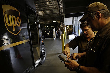 &lt;p&gt;United Parcel Service driver Richard Trzcinski, right, looks at an automated computer system with fellow driver Daniel Petranck in Roswell, Ga., on June 20.&#160;&lt;/p&gt;