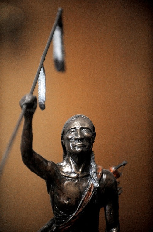 The statue of a Blackfeet Indian &quot;Connecting with Spirit&quot; sits on Johnson's desk at Glacier Bronze Works in Kalispell.