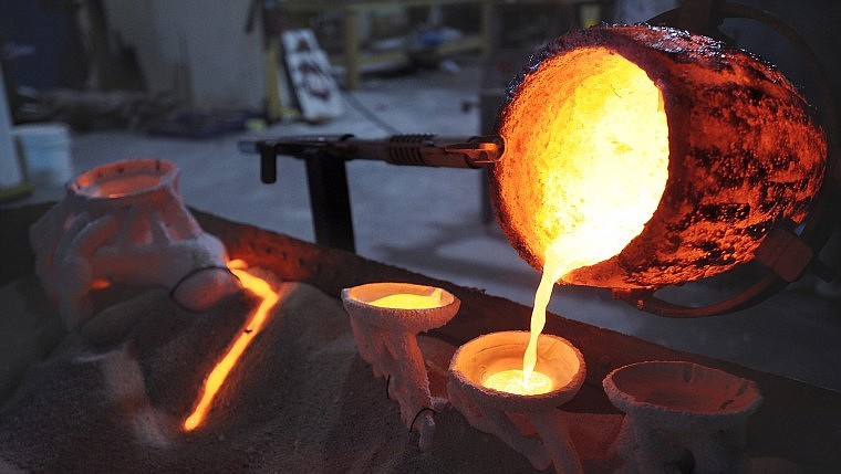 Coby Johnson pours molten bronze into casts using the lost-wax technique. Johnson said this is the process used by ancient Egyptians.