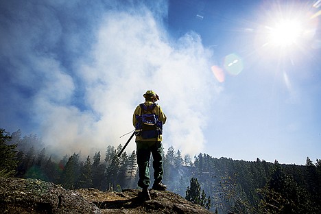 &lt;p&gt;James Neils, chief 702 with Hauser Lake Fire Protection District, holds a post as the northeast safety lookout over Lower Fifth Canyon in Q'emiln Park July 22 during a wildland fire.&lt;/p&gt;