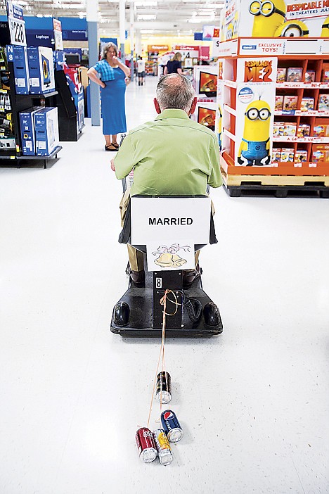 &lt;p&gt;Donald Evans rides a store scooter adorned with tin cans through the aisles of Walmart Friday, June 28, 2013 following his wedding at the Post Falls store.&lt;/p&gt;