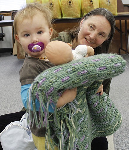 &lt;p&gt;Licensed massage therapist Mary Gertson git some unexpected help from Naomi, who was cradling her doll in a knitted blanket during the Lake County Public Health Department's monthly Parents as Teachers event. Gertson demonstrated how the mothers can massage their babies. Vince Lovato / Leader photo&lt;/p&gt;