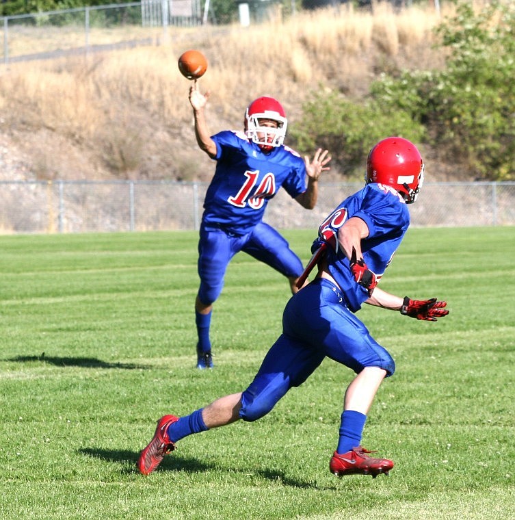 <p>Superior quarterback Billy Smith throws to teammate Matt
Campbell during a practice in August. </p>