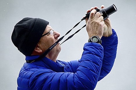 &lt;p&gt;Bob Kelly aims his camera toward an eagle flying over Beauty Bay near one of the eagle watching stations.&lt;/p&gt;