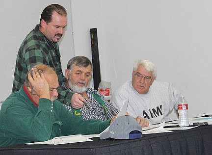 &lt;p&gt;Board members, from left to right, Jerry Laskody, Boone Cole, Tim Orr, and Gene Posivio review one of the draft resolutions during Tuesday's special FJBC board meeting in St. Ignatius.&lt;/p&gt;