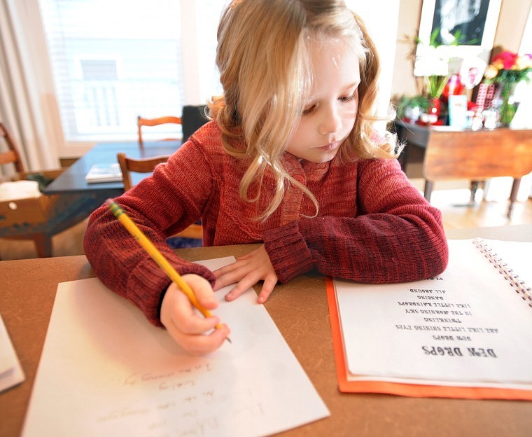 Maggie Gibson makes a copy of her award winning poem Dew Drops on Tuesday in her home in Kalispell.