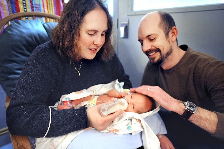 Erin and Ryan Reichman of Tacoma, Wash., feed their daughter Adeline Anina on Dec. 11 at Kalispell Regional Medical Center.