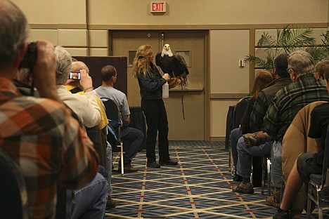 &lt;p&gt;Raptor biologist Jane Fink holds up Liberty, a 20-year-old bald eagle, on Sunday at The Coeur d'Alene Resort convention center.&lt;/p&gt;