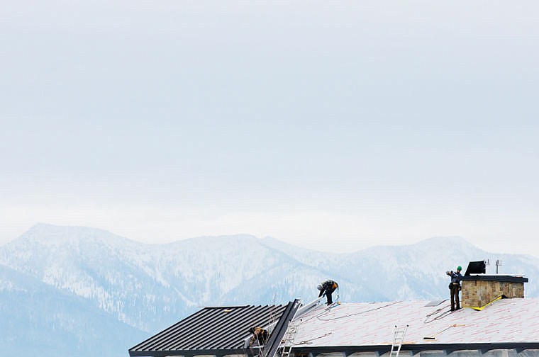 &lt;p&gt;Workers install roofing Thursday afternoon on the Glacier Eye Clinic near Glacier High School. Dec. 26, 2013 in Kalispell, Montana. (Patrick Cote/Daily Inter Lake)&lt;/p&gt;