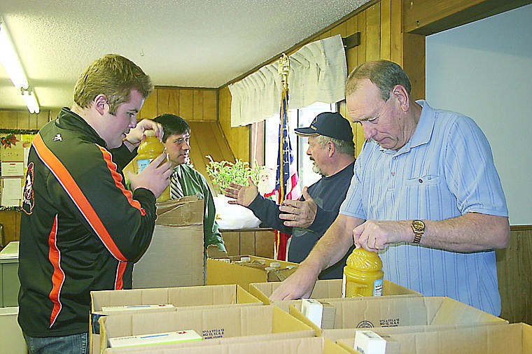 &lt;p&gt;Ben Gorham unloads orange juice while Carl Pope loads them into the boxes. Pope delivers the boxes every week to those who are unable to pick them up.&lt;/p&gt;