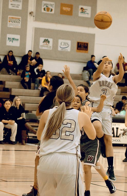 Flor Araujo, 3, of Royal High School fires a jump pass to teammate Kayla Smith, 32, during Saturday night's 51-21 victory over Wahluke in SCAC East girls basketball.