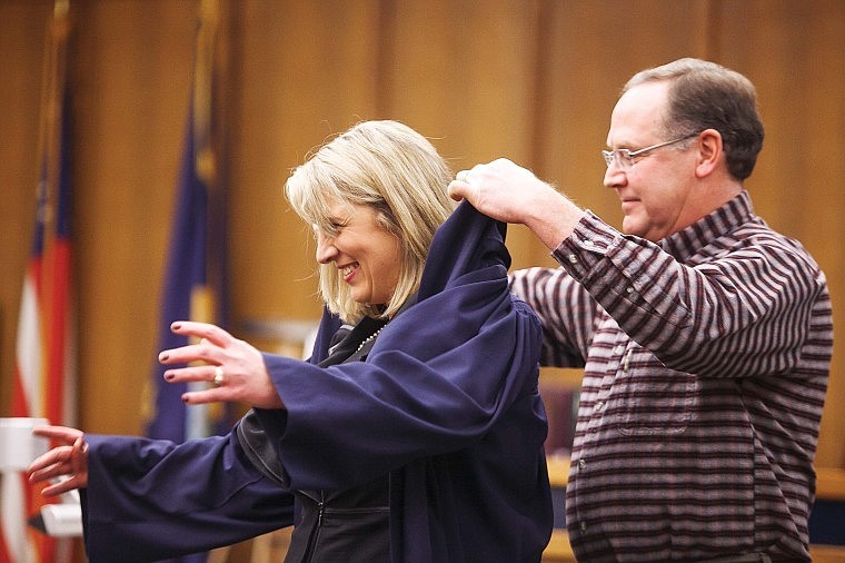 &lt;p&gt;Brad Wright helps his wife, Heidi Ulbricht, into her new robe during her swearing-in ceremony Monday morning at the Flathead County Justice Center. Ulbricht succeeds Stewart Stadler as Flathead District Court judge. &#160;&lt;/p&gt;