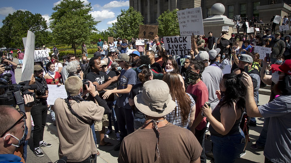 A crowd of protesters turn to confront a counter-protester during a heated moment that organizers  at the Idaho Statehouse Sunday, May 31, 2020 in Boise.  Protesters were demonstrating over the death of George Floyd, a black man who was in police custody in Minneapolis. Floyd died after being restrained by Minneapolis police officers on May 25. (Darin Oswald/Idaho Statesman via AP)
