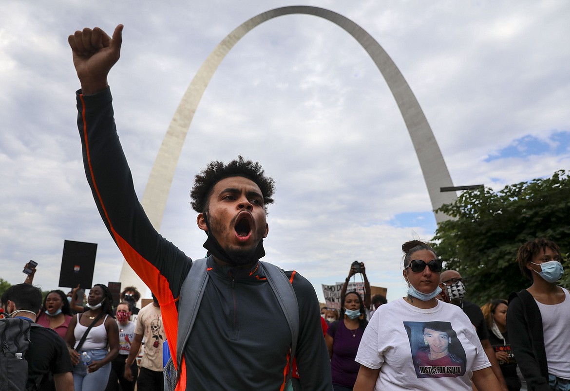 Johnnie Williams chants with the crowd as they march off the Gateway Arch grounds during an event organized by ExpectUS, in Downtown St. Louis on Monday, June 1, 2020. Protesters were demonstrating against the death of George Floyd, who died May 25 after being detained by Minnesota police. (Colter Peterson/St. Louis Post-Dispatch via AP)