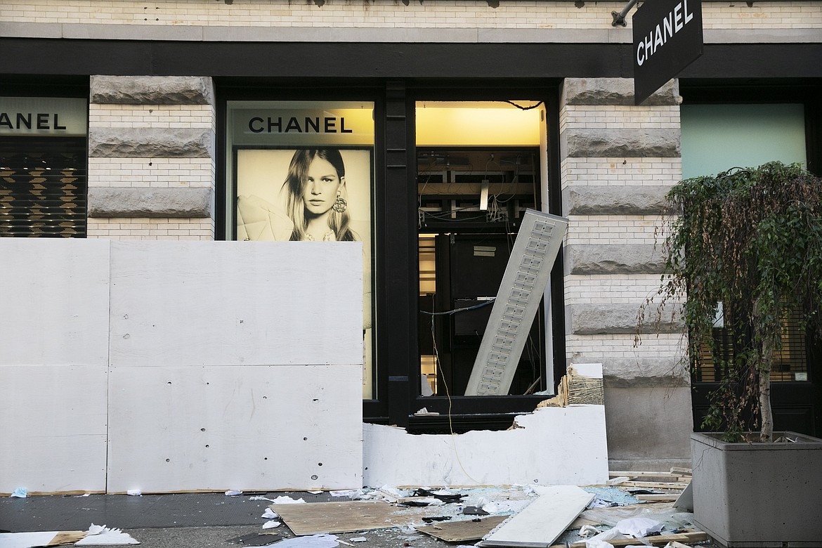 The windows of a Chanel store are broken Monday, June 1, 2020, following protests in the SoHo neighborhood of New York. Protests were held throughout the country over the death of George Floyd, a black man who died after being restrained by Minneapolis police officers on May 25.  (AP Photo/Mark Lennihan)