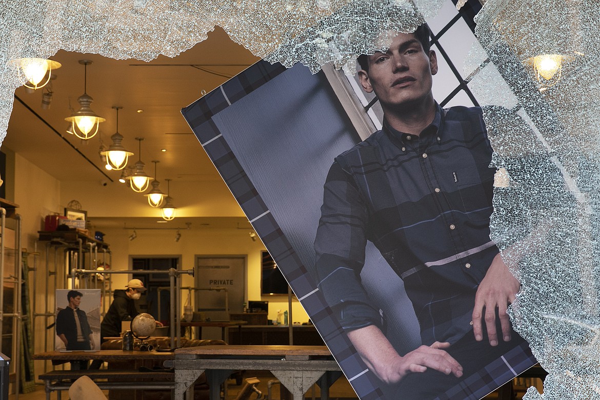 A store window is smashed, Monday, June 1, 2020, in the SoHo neighbourhood of New York. Protesters broke into the store Sunday night in reaction to George Floyd's death while in police custody on May 25 in Minneapolis. (AP Photo/Mark Lennihan)