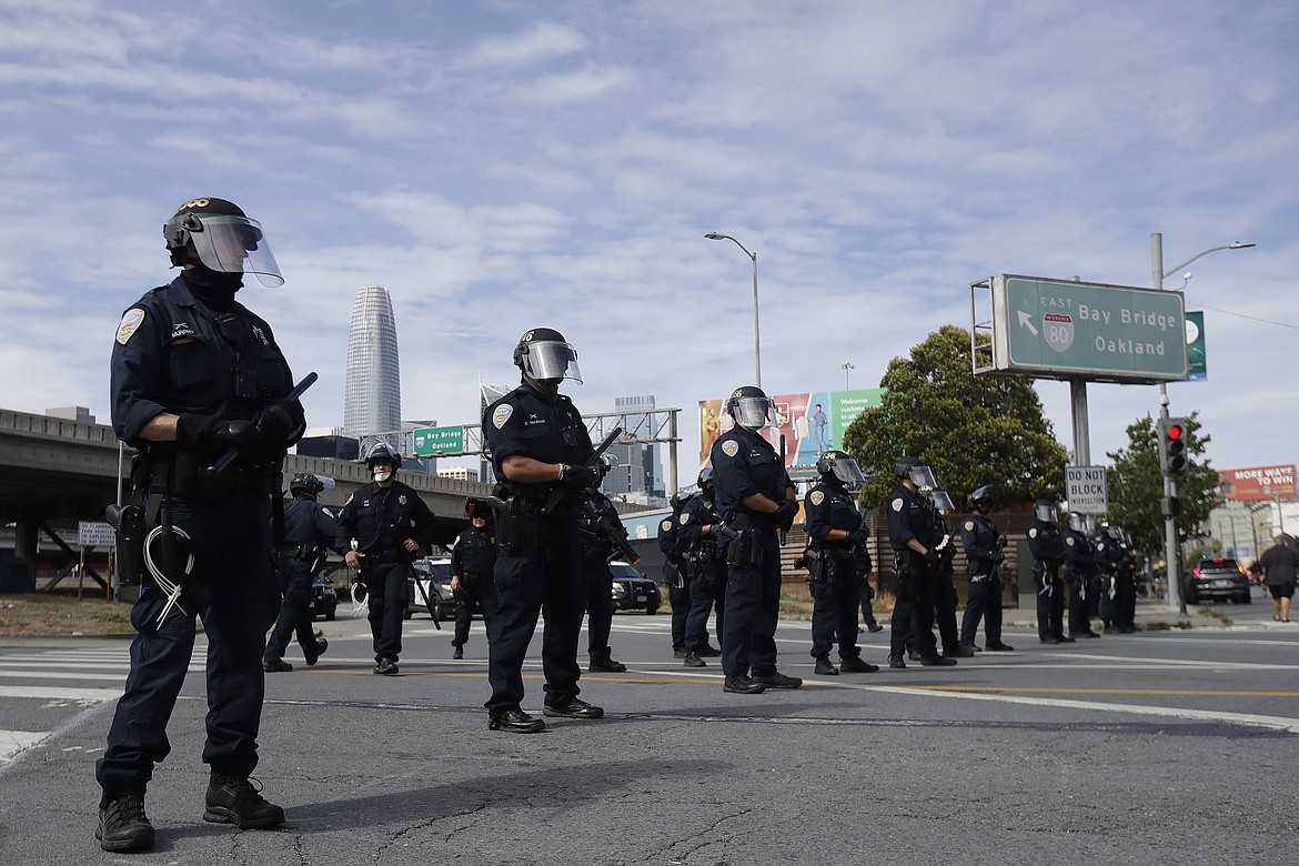Police officers block a street near the San Francisco-Oakland Bay Bridge in San Francisco, Sunday, May 31, 2020, at a protest over the Memorial Day death of George Floyd. Floyd was a black man who was killed in police custody in Minneapolis on May 25. (AP Photo/Jeff Chiu)