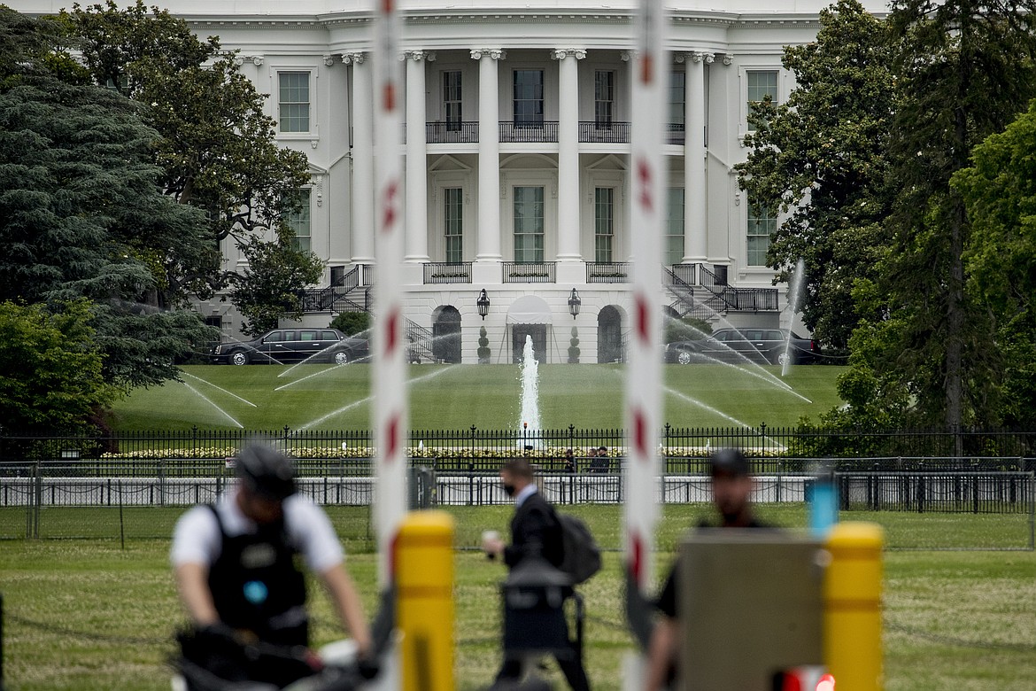 The White House is visible as uniformed Secret Service agents stand at a checkpoint on Constitution Avenue in the morning hours in Washington, Tuesday, June 2, 2020, as protests continue over the death of George Floyd. Floyd died after being restrained by Minneapolis police officers. (AP Photo/Andrew Harnik)
